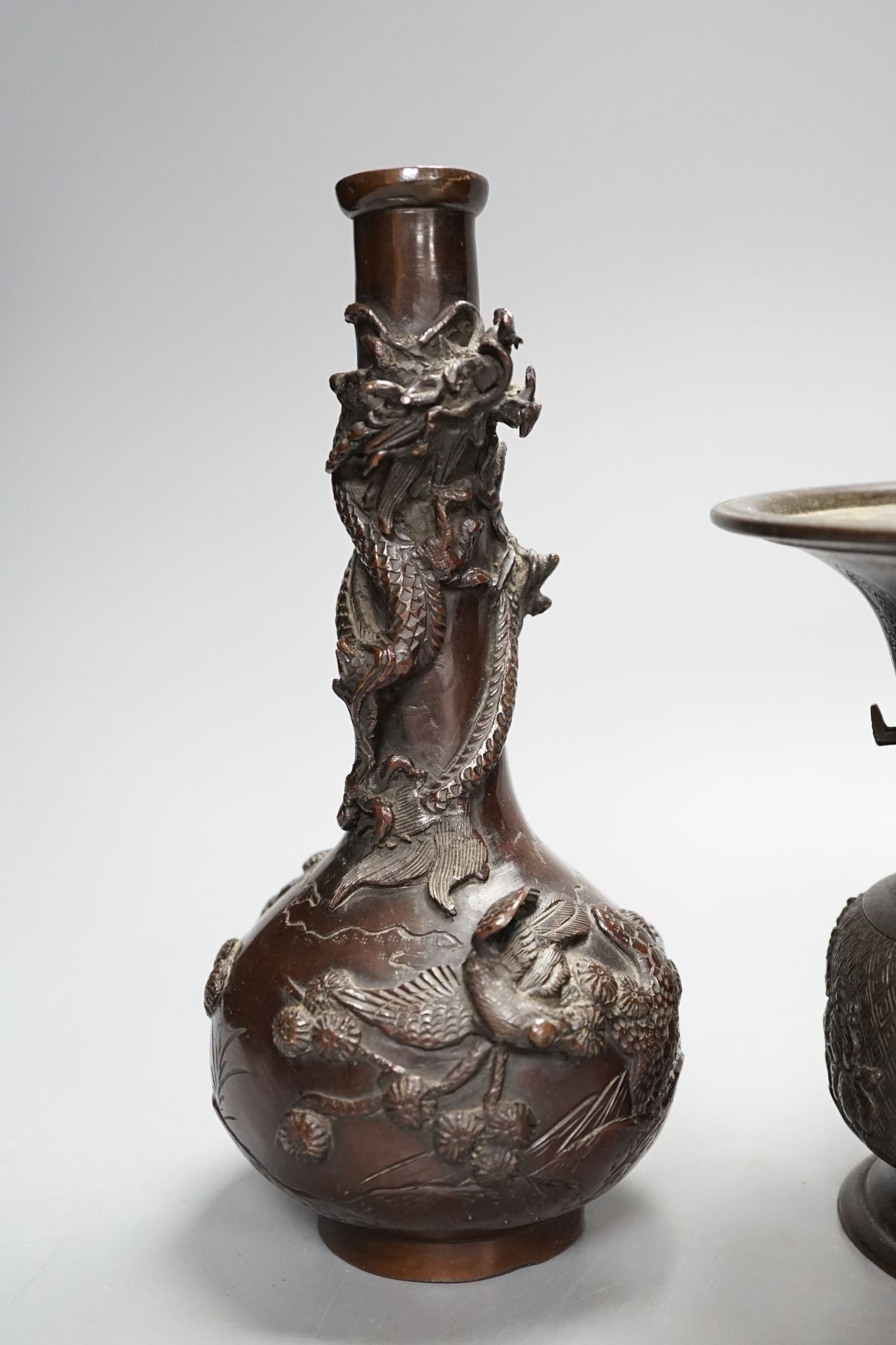 A pair of Japanese Meiji period bronze ‘dragon’ bottle vases and another, 21cm